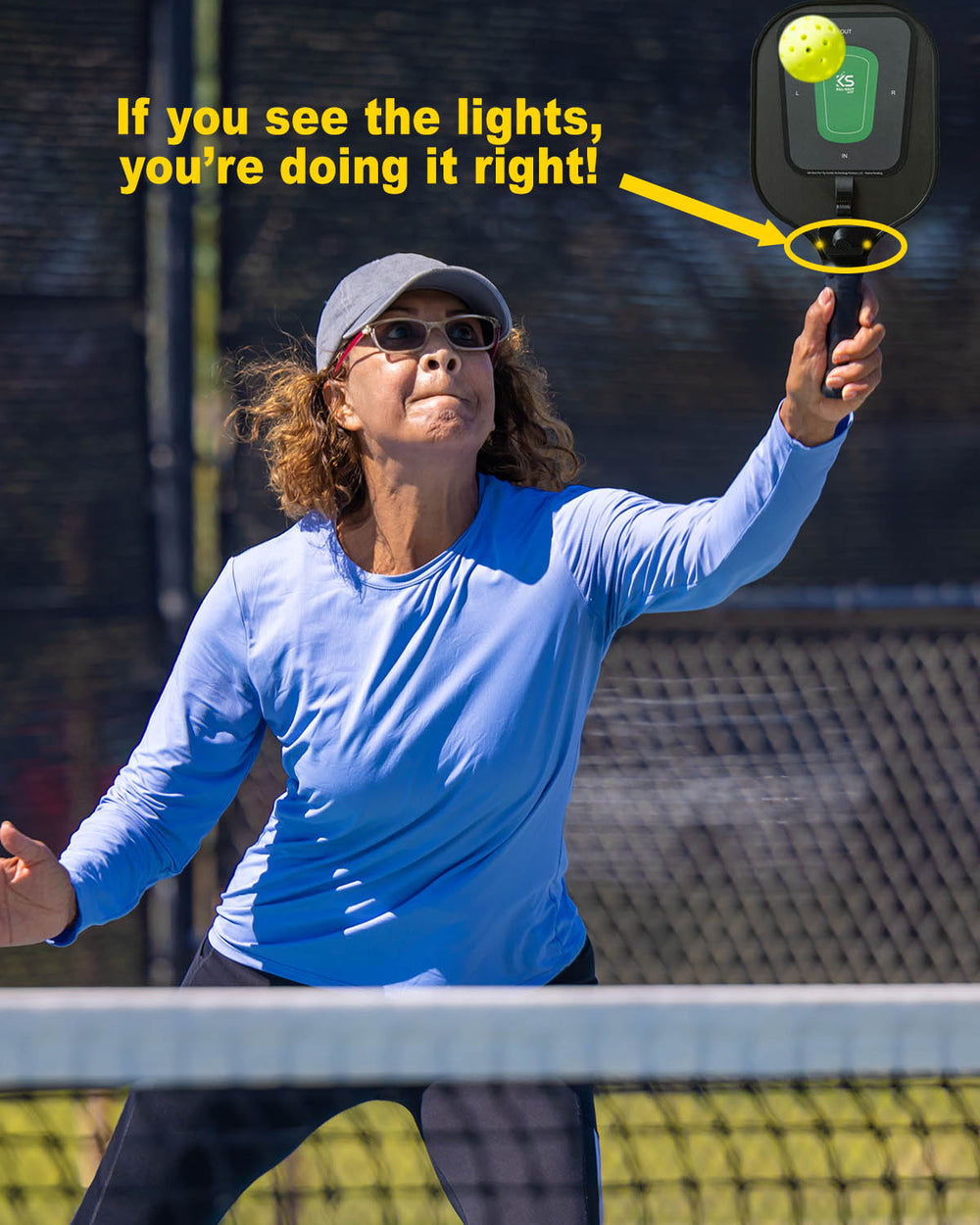 Woman playing pickleball with Kill-Shot Pro paddle, a pickleball training tool that gives you instant feedback on your ball placement on the training paddle.